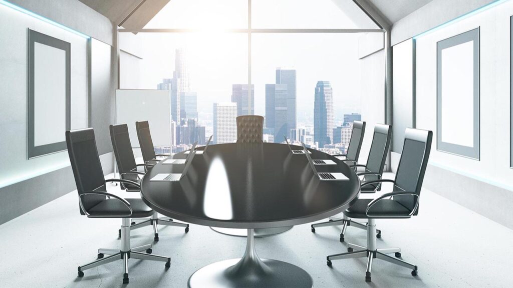 an empty conference room with table and chairs