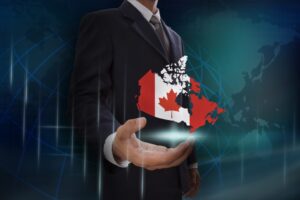 Canada map and flagged in a businessman's hand
