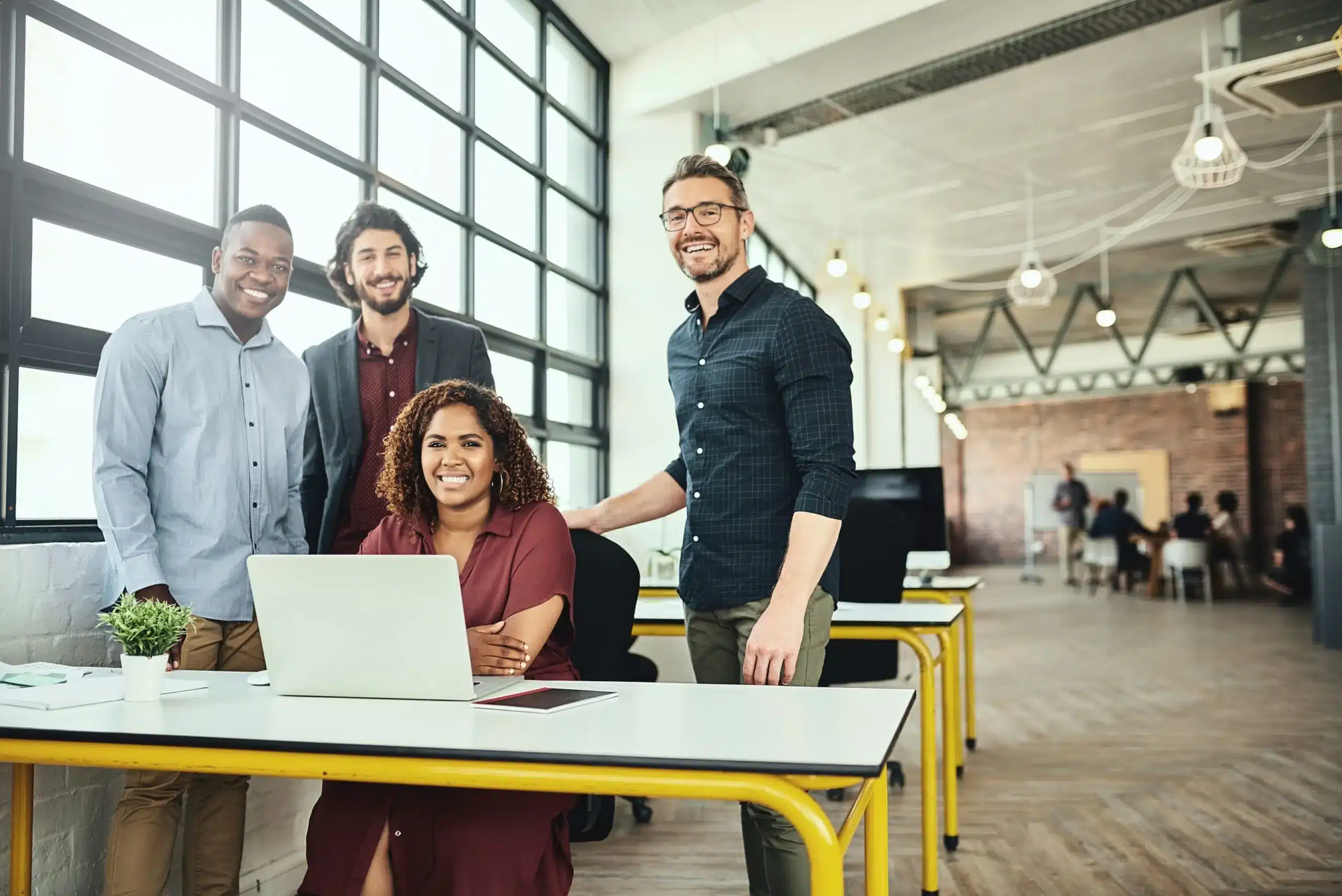 A team of tech professionals working in a Canadian office – Specialized knowledge workers relocated through the intra-company transfer program, supporting business operations of a parent company expanding into Canada.