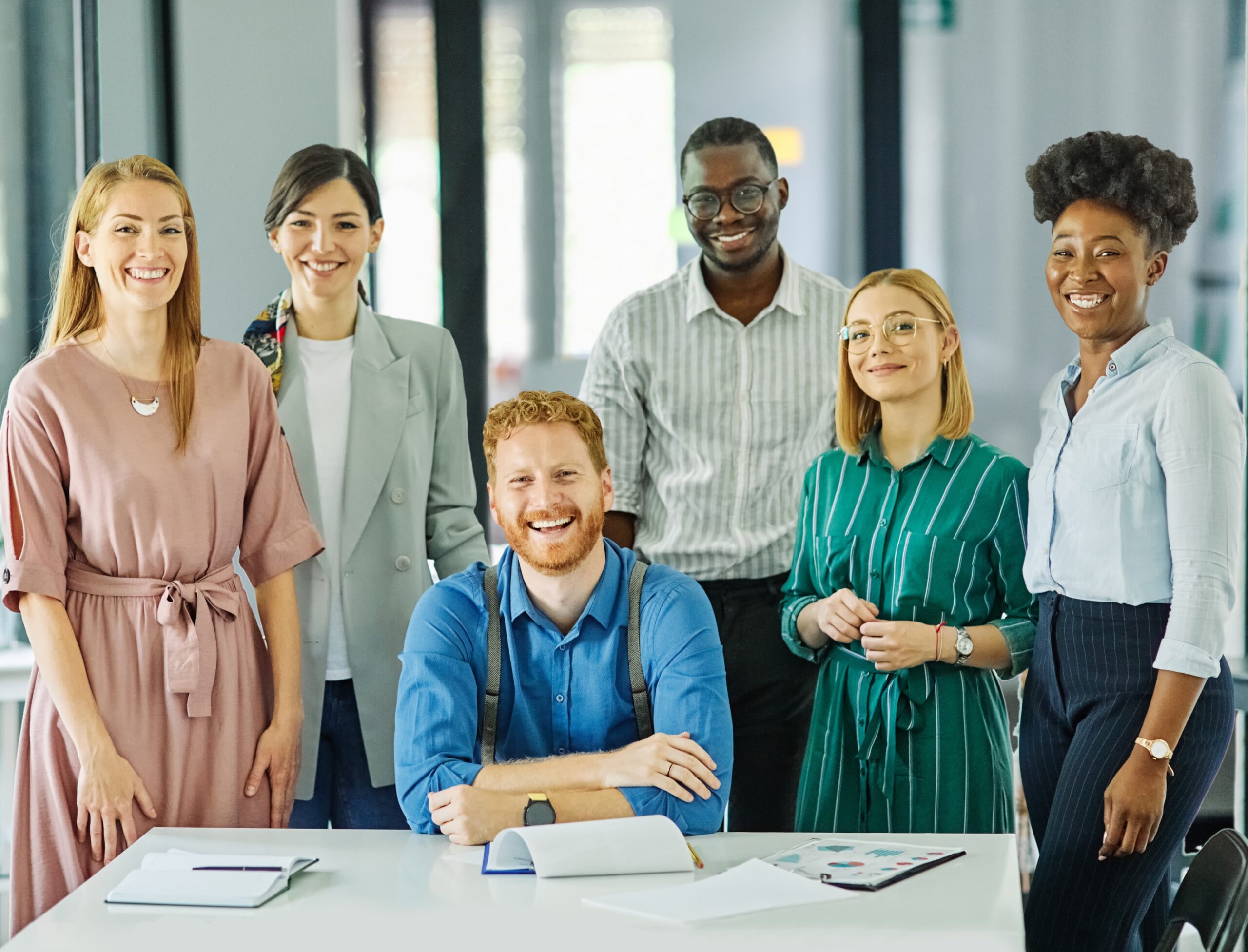 A group of young, diverse immigrant entrepreneurs in Canada smiling together, representing the innovative spirit of immigrant entrepreneurship and their growing role in Canada’s population.