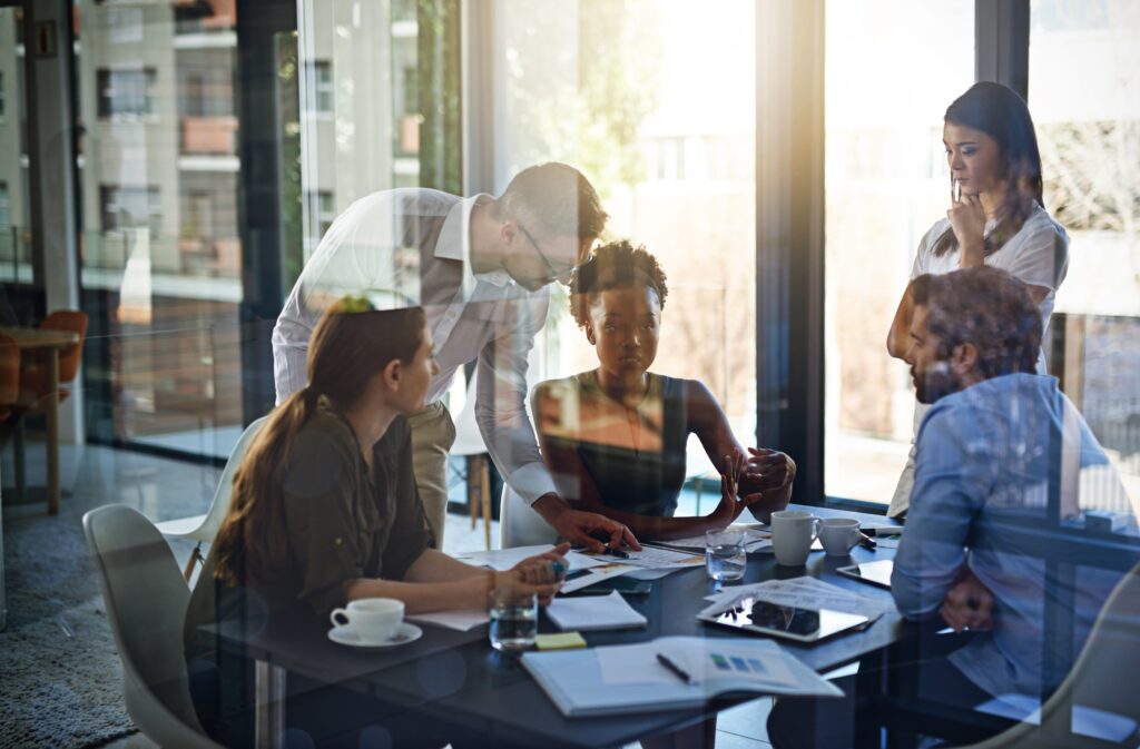 Business owners reviewing plans and financial reports, appearing concerned about limited results and evaluating their next strategic move.