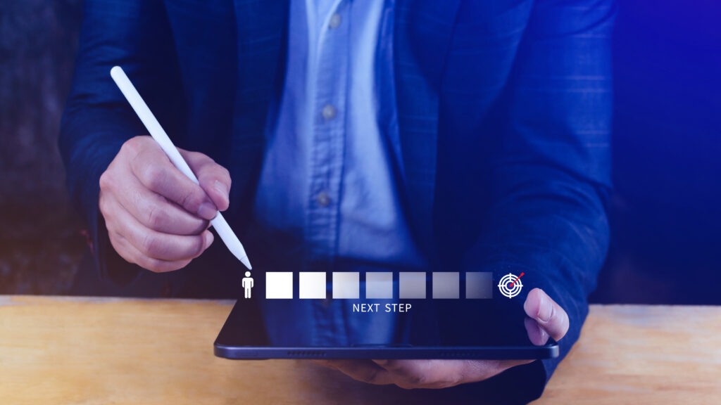 The entrepreneur works on an iPad, focusing on careful planning and preparing documents like the commitment certificate and permanent resident travel document to navigate lengthy processing times.
