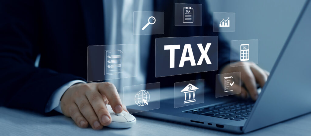 Close-up of the entrepreneur’s hand holding a laptop, keyboard, and mouse — symbolizing the hands-on effort in developing a viable business idea, managing intellectual property, and meeting angel investor group expectations.