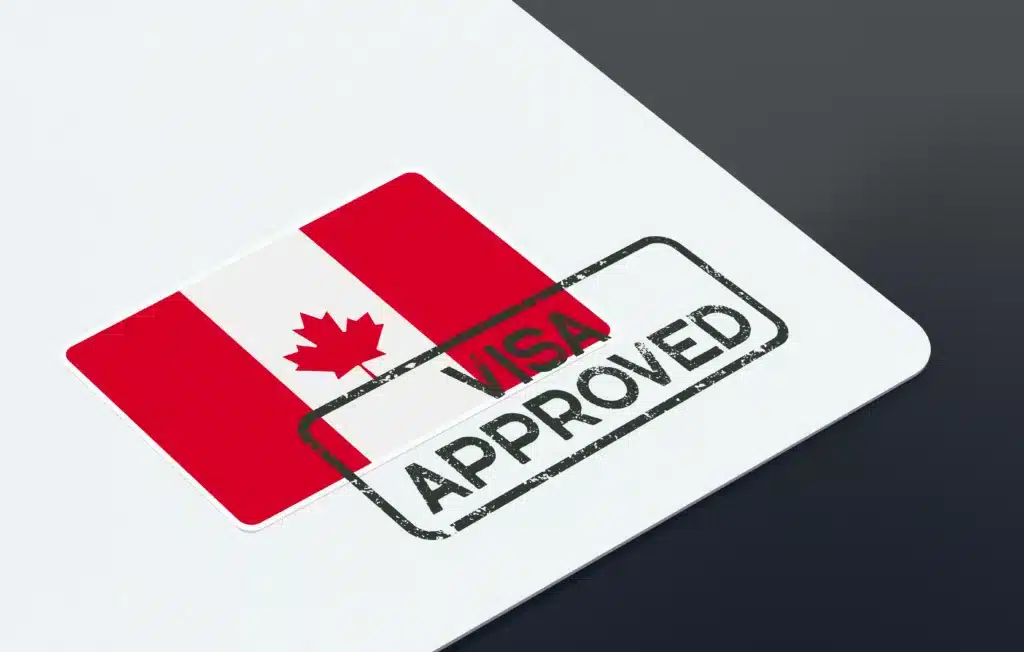 A Canadian flag sticker on a document with a black Visa Approved stamp across it, alongside a Letter of Support, symbolizing approval for a Canadian visa application.