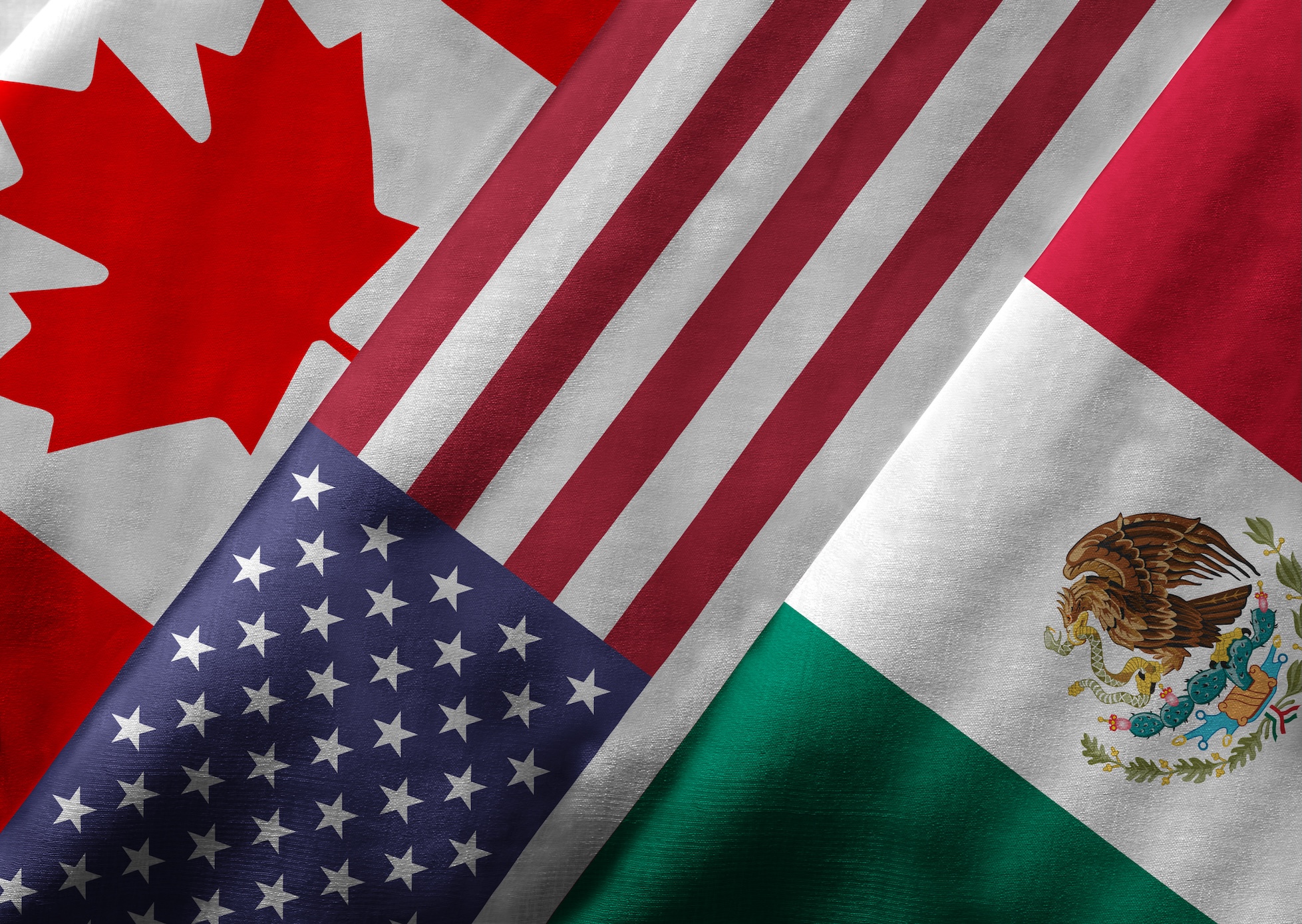 The flags of Canada, United States, and Mexico overlapping in a symbolic representation of the Canada United States Mexico Agreement (CUSMA), facilitating work permits for eligible citizens and foreign nationals with specialized knowledge across professional occupations, including computer systems analyst baccalaureate holders, management consultant baccalaureate professionals, and those with licenciatura degrees seeking valid work permits through Canadian employers, while Mexican citizens and others with equivalent professional experience navigate the visa office process to enter Canada under the United States Mexico Agreement CUSMA framework for professional licenses and job offers requiring successful completion of labour market impact assessments.