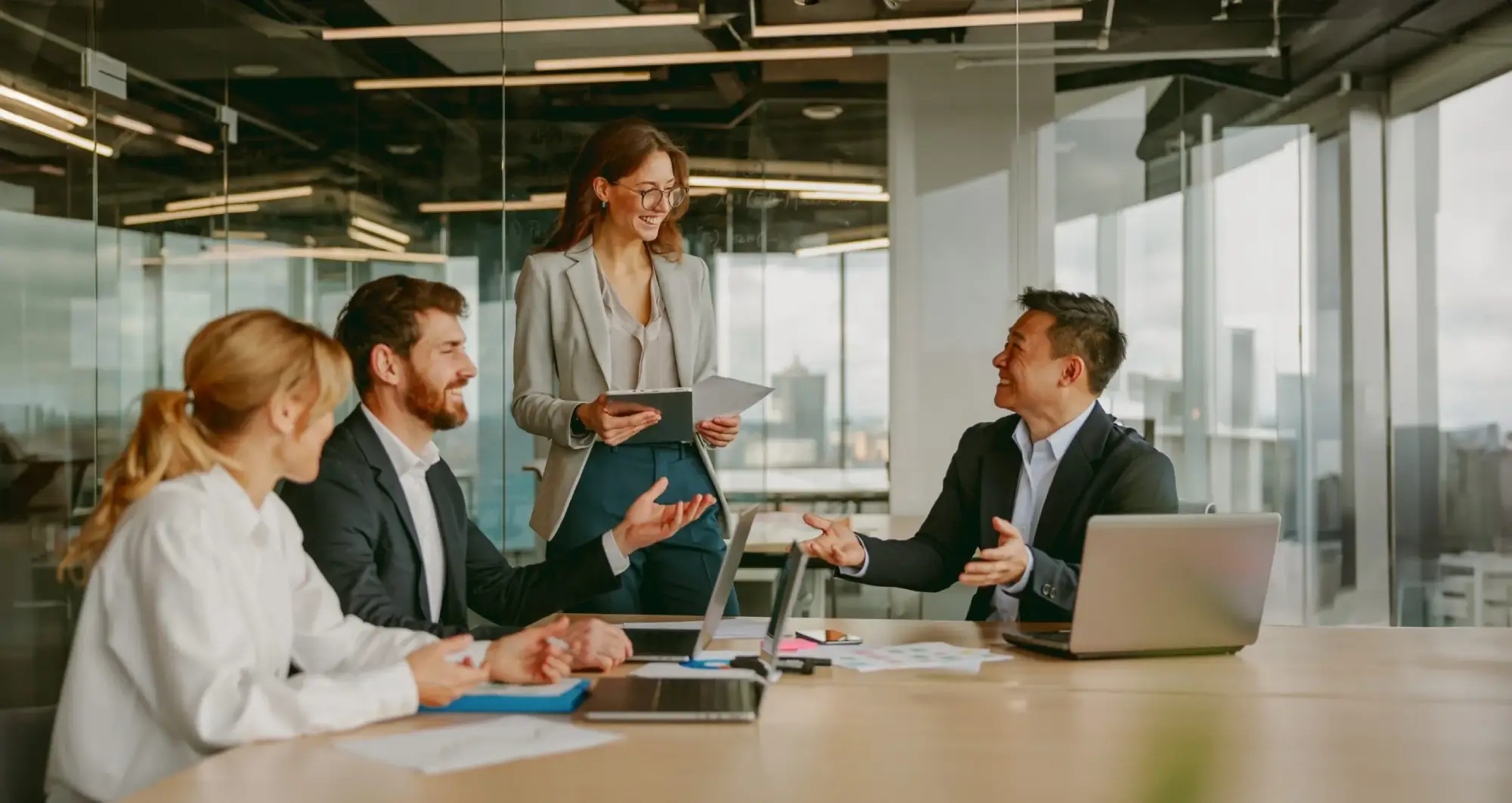 Group of diverse business professionals in a modern office discussing plans, symbolising collaborative legal and immigration solutions in Canada.