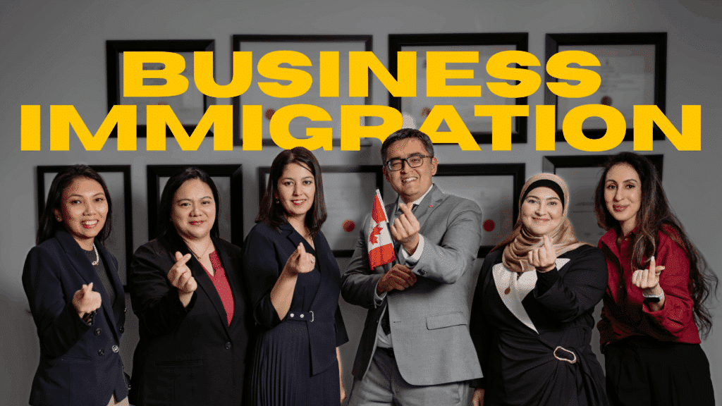 A diverse group of six professionals in business attire stand smiling under large yellow text reading Business Immigration. One person, likely among experienced business immigration lawyers, holds a small Canadian flag as they gesture with their fingers in a heart shape.