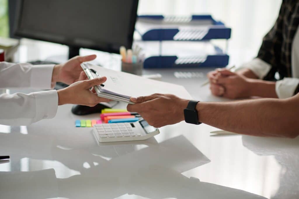 Immigration lawyer reviewing a client's Canadian visa application documents across a desk